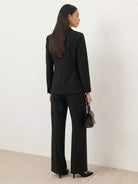 Structured double-breasted blazer with gold lion-head buttons and wide-leg trousers co-ord set