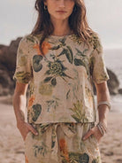 woman wearing relaxed cotton linen set with short-sleeve top and straight-leg pants in monochrome