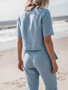 woman wearing breathable cotton linen set with short-sleeve top and straight-leg pants in monochrome tones