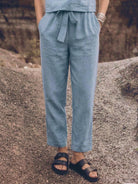 Woman wearing relaxed fit cotton linen set with short-sleeve top and straight-leg pants in monochrome tones