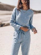 Woman wearing cotton-linen monochrome relaxed two-piece set with longline top and wide-leg pants