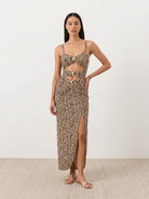Gold-detail cutout one-piece swimsuit with ruched panels and midi wrap skirt on white background