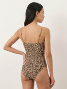 One-piece gold-detail cutout swimsuit set with ruched panels and midi wrap skirt beachwear