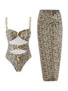 Gold-detail cutout one-piece swimsuit with ruched panels and matching midi wrap skirt on white background