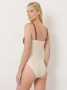 Gold-detail cutout one-piece swimsuit with ruched panels and matching midi wrap skirt for beachwear