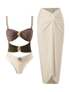 One-piece gold-detail cutout swimsuit set with ruched fabric and midi wrap skirt on a white background