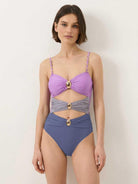 Gold-detail cutout one-piece swimsuit with ruched panels and midi wrap skirt on white background