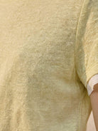 100% linen tee with rolled cuff sleeves and relaxed scoop neckline