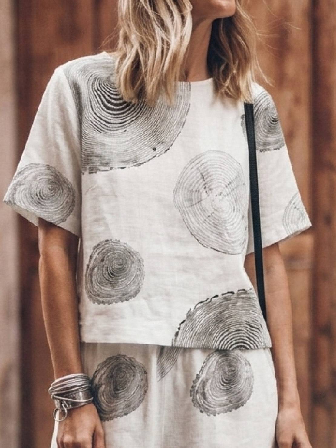 Woman wearing a soft cotton loose fit co-ord set with relaxed shoulders and wide-leg trousers in a neutral tone.