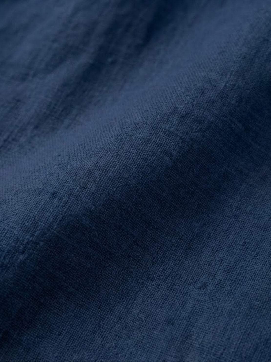Close-up of deep navy blue pure linen fabric texture for Pure Linen Age-Defying Shirt