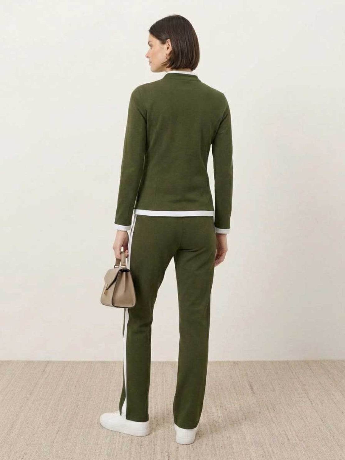 women wearing sleek contrast zip two-piece outfit standing against white background