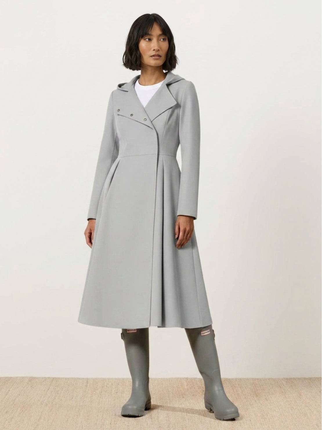 Women wearing water-repellent A-line hooded raincoat with belt outdoors
