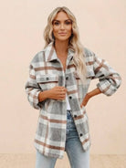 Woman wearing comfy flannel classic button-down shirt in beige, gray, and brown plaid pattern