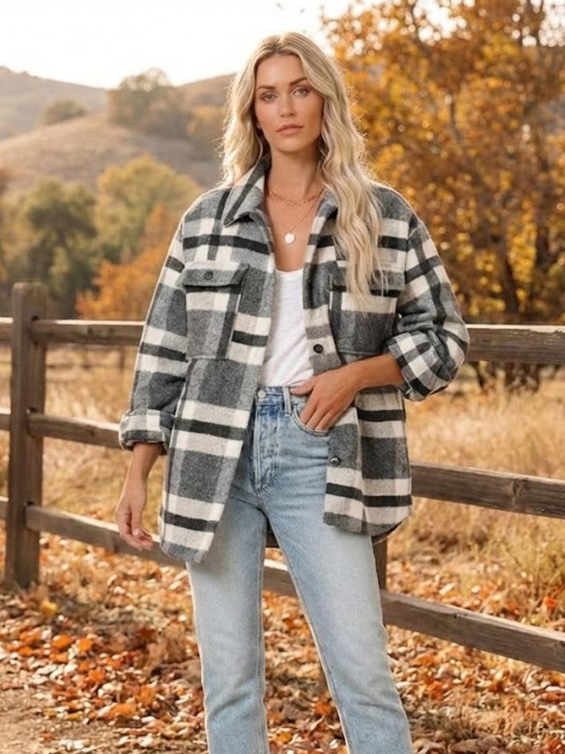 woman wearing comfy flannel classic button-down shirt in black and white plaid outdoors in autumn