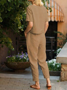 Woman wearing breathable 100% cotton linen set with relaxed top and straight-leg pants in monochrome tones