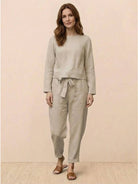 Woman wearing Cotton-Linen Monochrome relaxed longline top and wide-leg pants set in soft, natural fabric