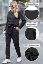 Woman wearing black cotton-linen monochrome relaxed longline top and fluid wide-leg pants with wide cuff hem and big pockets