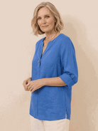 white pure linen age-defying shirt with button details on hanger