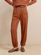 European Minimalism relaxed knit sweater top and trouser set in warm brown tones with casual shoes