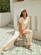 Woman wearing first class travel comfort two-piece set in soft pleated fabric with wide-leg pants and matching top