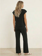 Elegant first class travel two-piece set with pleated wide-leg pants and soft viscose-acrylic fabric for wrinkle-resistant comfort