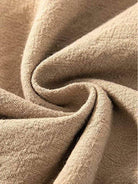 Close-up of beige high-waist palazzo pants fabric made of cotton and linen blend