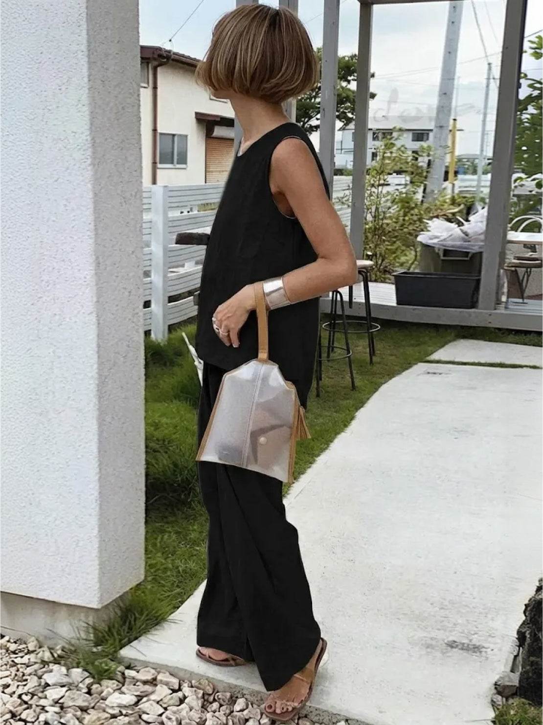 Loose solid color sleeveless two-piece set laid flat with size chart and product details