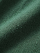 Close-up of green loose solid color fabric texture for two-piece set