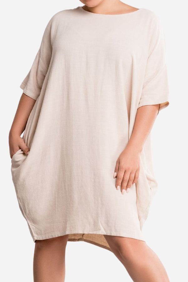 Nude oversized premium linen ovoid dress with short sleeves and pockets, soft breathable fabric.