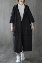 One size fits all oversized water resistant windbreaker jacket with hood and large front pockets, styled for layering and lightweight protection against wind and rain.