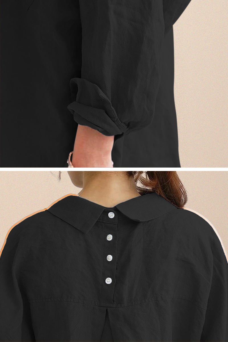Close-up of black oversized linen shirt with rolled sleeves and back button detailing on breathable cotton-linen blend fabric