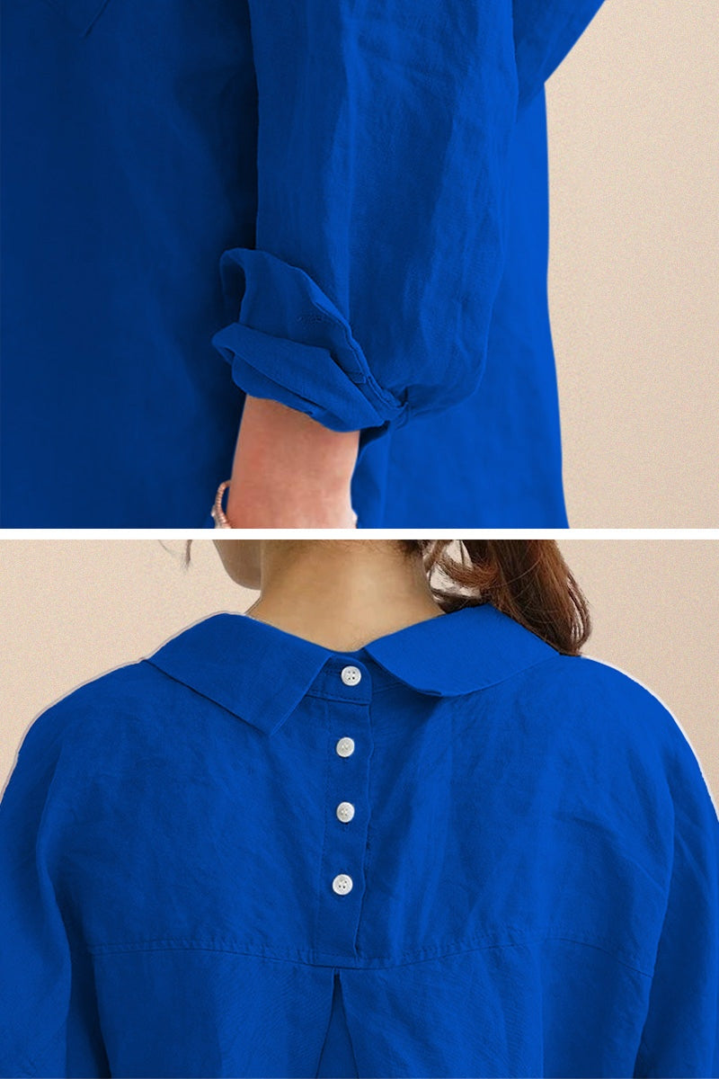 Back view of oversized linen shirt in vibrant blue with button details and rolled-up sleeves