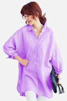 Woman wearing oversized lavender linen shirt with relaxed fit and button front