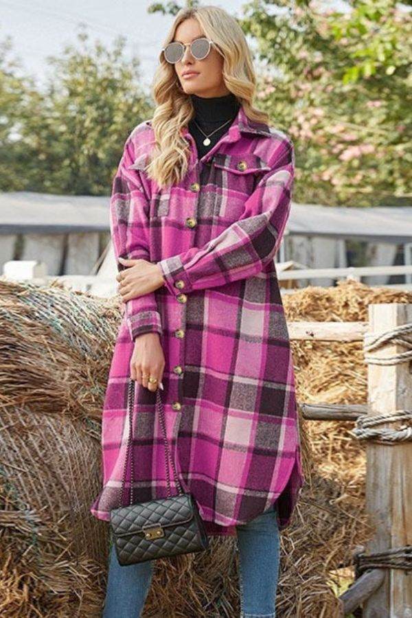 Oversized medium-length plaid overshirt in pink and purple plaid pattern worn with jeans and sunglasses outdoors