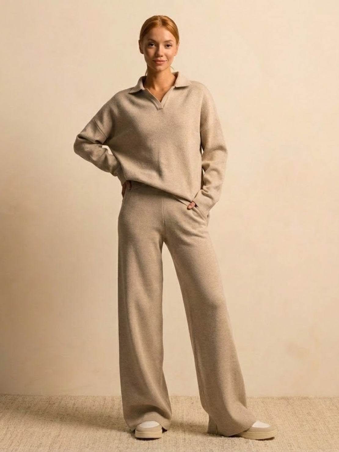 woman wearing plush preppy camel two-piece set with polo collar sweater and wide-leg pants against beige background