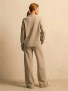woman wearing plush and preppy camel two-piece set with long sleeves and wide-leg pants standing against beige background
