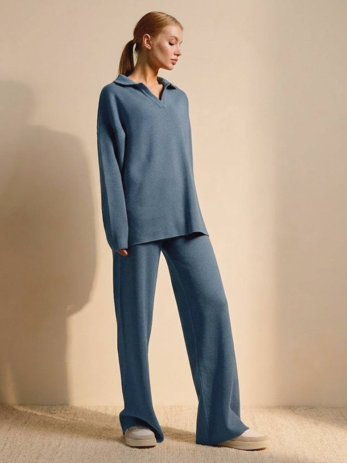 woman wearing plush and preppy camel two-piece set in soft blue with polo collar pullover and wide-leg pants