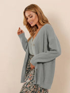 Relaxed fit oversized button-down knitwear cardigan in soft gray worn with floral skirt and tank top