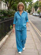 Woman wearing a monochrome relaxed shirt and trousers two-piece set in casual stylish outfit