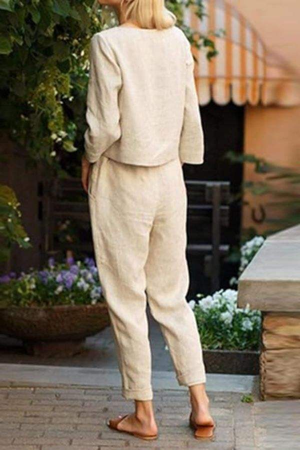 Back view of woman wearing beige Cotton-Linen Monochrome Capsule loose top and wide-leg pants set outdoors.