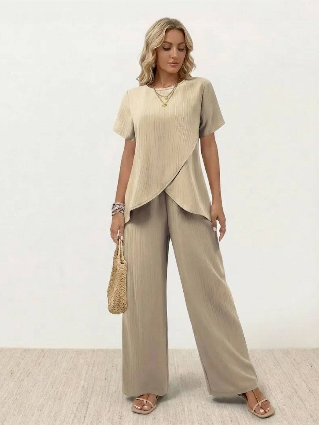 Two-piece women's outfit featuring textured elegance with asymmetrical top and wide-leg pants in soft stretch fabric
