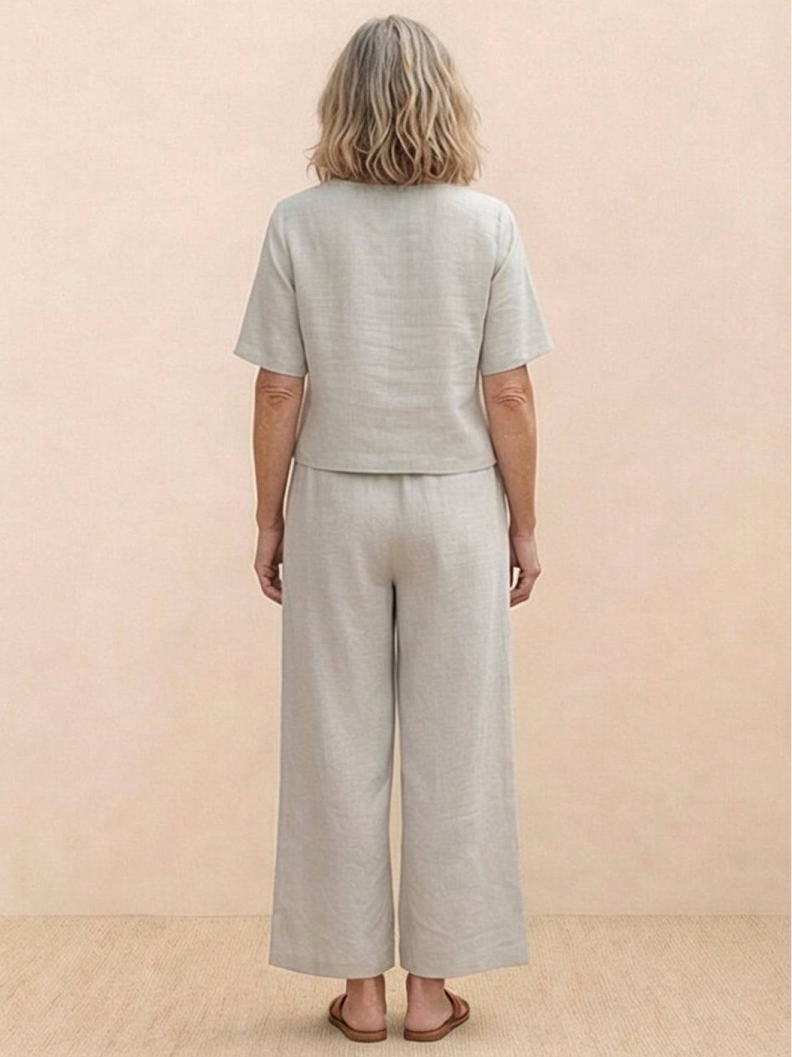 Woman wearing a loose fit co-ord set with soft-tailored top and wide-leg bottoms in a relaxed, breathable fabric.