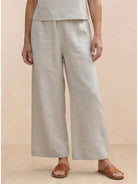 Woman wearing a relaxed loose fit co-ord set with soft-tailored top and wide-leg bottoms in breathable fabric