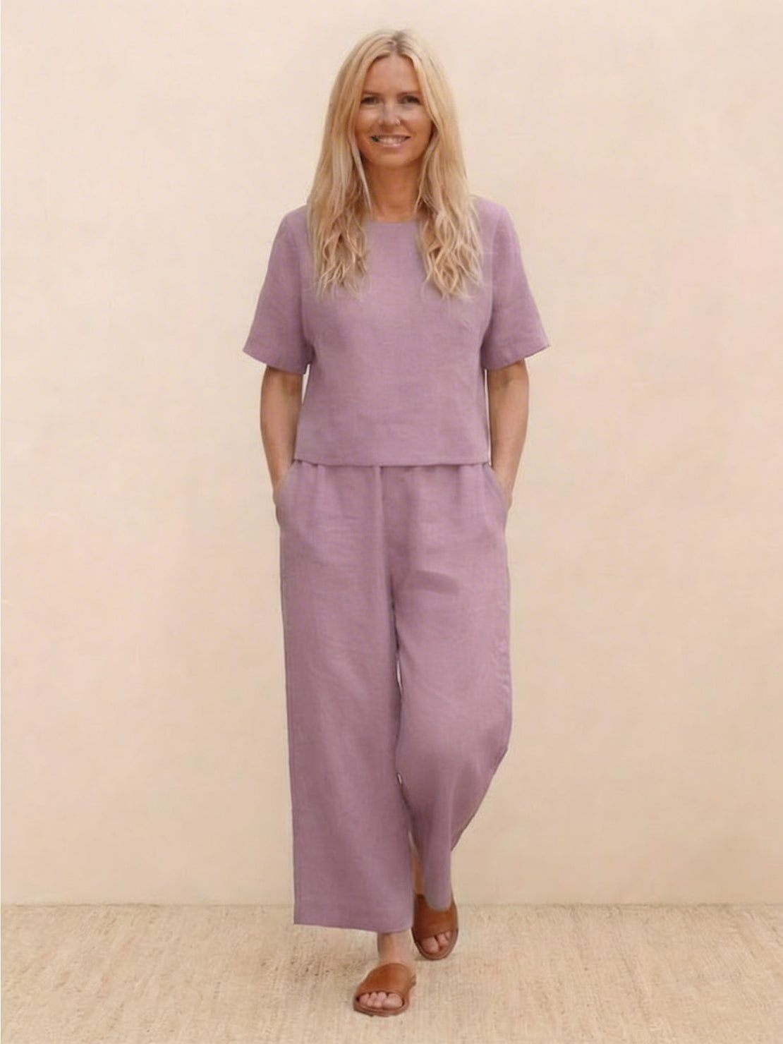 Woman wearing a relaxed loose fit co-ord set with soft-tailored top and wide-leg bottoms in solid color