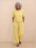 Woman wearing a loose fit co-ord set with soft-tailored top and wide-leg bottoms in a breezy fabric