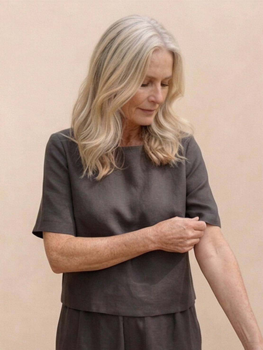 Woman wearing a loose fit co-ord set with a soft-tailored top and wide-leg bottoms in relaxed style