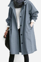 Trendy oversized Rain Couture Windbreaker in blue, lightweight and water-resistant jacket with adjustable hood and multiple pockets.