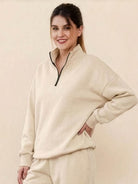 Woman wearing beige ultra-soft and comfy co-ord tracksuit set with zip-up top and matching pants
