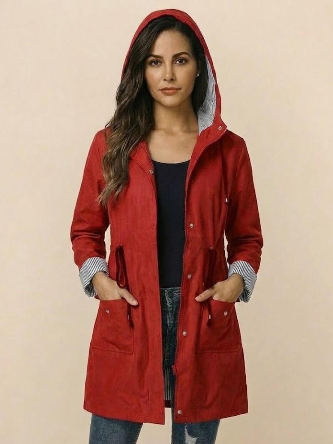 woman wearing red water resistant windbreaker with hood and striped cuffs