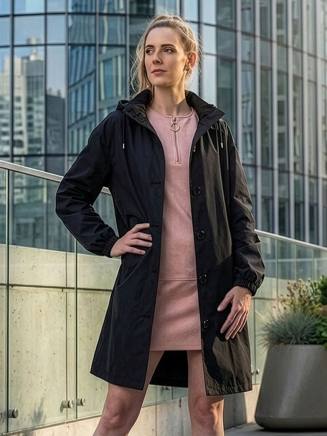 Water-resistant oversized windbreaker rain jacket with hood and multiple pockets for outdoor activities